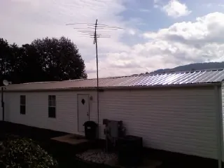 New metal roof on a single wide mobile home with a TV antenna in Swarthmore