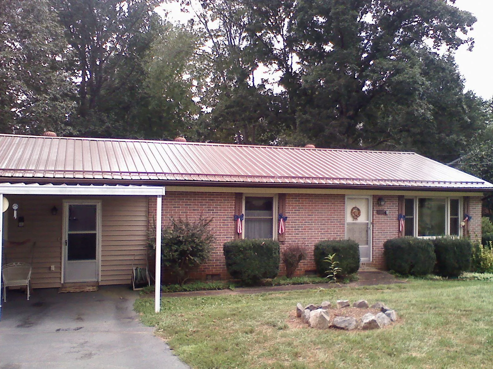 Bronze metal roof and carport on a brick ranch home — Roof Repair work by our crew in Swarthmore